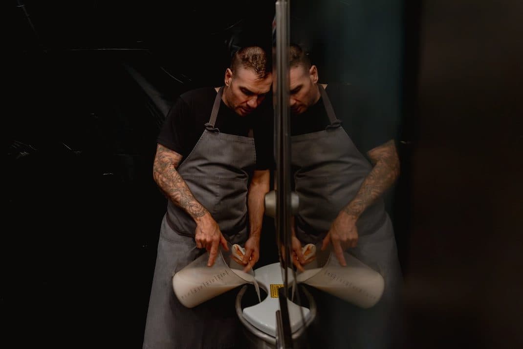 a chef pours milk into a container